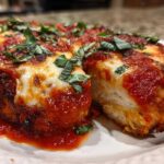 A cross-section view of Easy Chicken Parmesan covered in melted mozzarella, rich tomato sauce, and fresh basil.