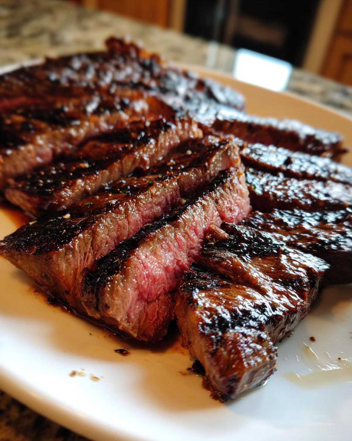 Close-up of sliced, medium-rare steak showing a beautiful crust, achieved with the Carne asada marinade.