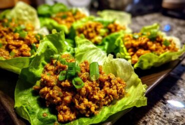 Close-up of delicious chicken lettuce wraps filled with savory ground chicken and topped with fresh green onions.