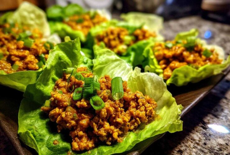 Close-up of delicious chicken lettuce wraps filled with savory ground chicken and topped with fresh green onions.
