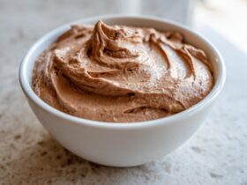 A close-up of creamy, swirled chocolate dip presented in a small white bowl.