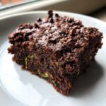 Close-up of a rich, fudgy square of Gluten Free Zucchini Brownies topped with chocolate chips.
