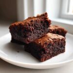 Close-up of fudgy, rich chocolate brownies, likely from gordon ramsay’s chocolate brownies were the recipe.