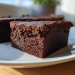 Close-up of a dense, fudgy slice of chocolate brownie, likely from gordon ramsay’s chocolate brownies were the recipe.