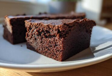 Close-up of a dense, fudgy slice of chocolate brownie, likely from gordon ramsay’s chocolate brownies were the recipe.
