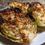 Close-up of roasted cabbage recipe wedges with a golden brown, crispy breadcrumb topping.