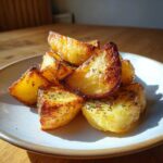 Close-up of perfectly roasted Amazing Greek Lemon Potatoes, golden brown and seasoned with herbs.