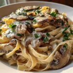 Close-up of rich Creamy Garlic Mushroom Pasta featuring fettuccine noodles, sliced mushrooms, and fresh parsley garnish.