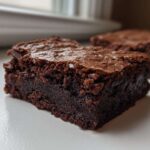 Close-up of a fudgy, dark chocolate slice of Brown Butter Brownies with a crackly top.