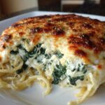 A serving of creamy Spinach & Ricotta Pasta Bake with a bubbly, browned cheese crust.