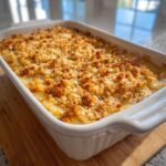A baked Tennessee Onions Casserole in a white dish with a golden, crunchy topping.
