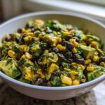 Close-up of a bright, chunky Avocado Salad featuring diced avocado, black beans, and corn in a white bowl.